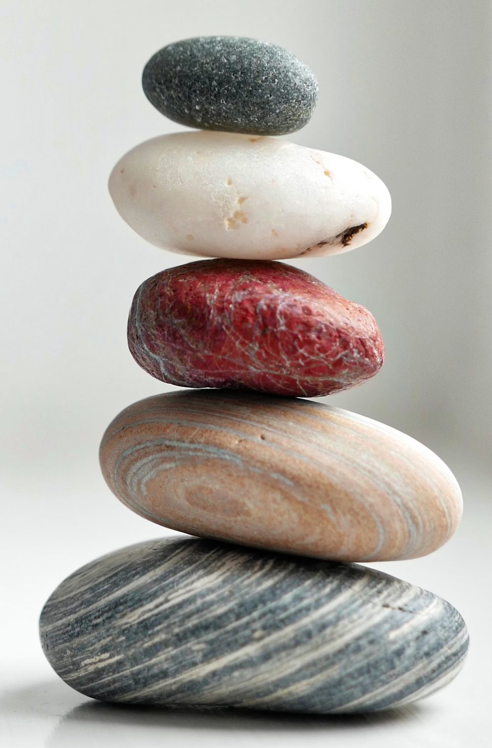 A balanced stack of naturally striped stones, a symbol of calm and balance